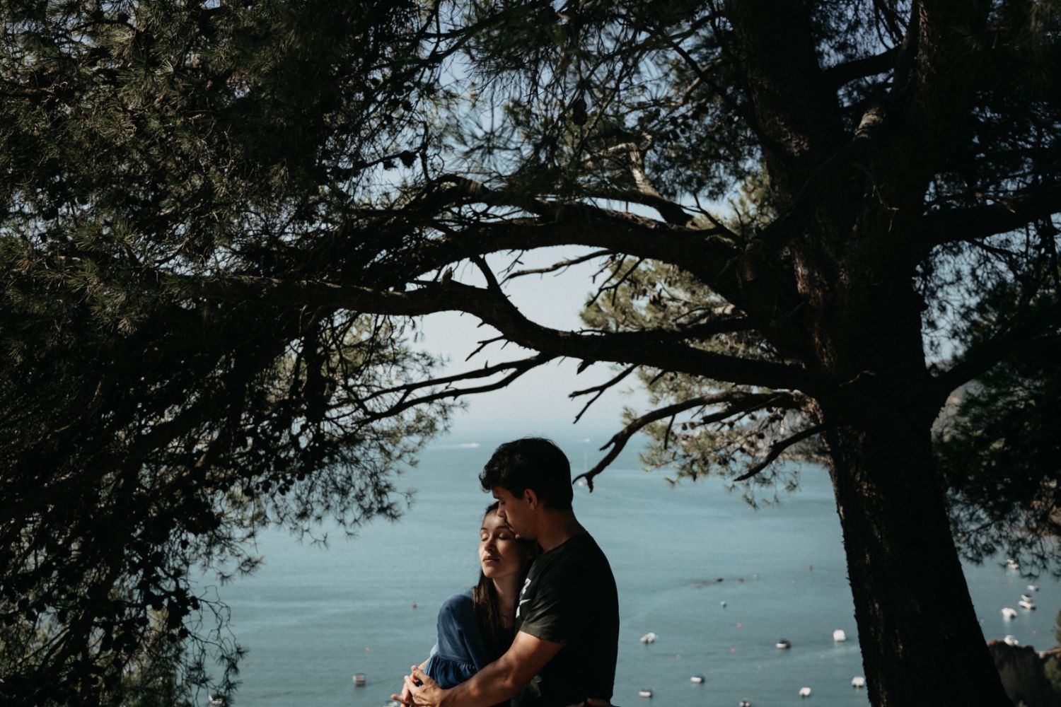 Couple hugging in park in front of lake